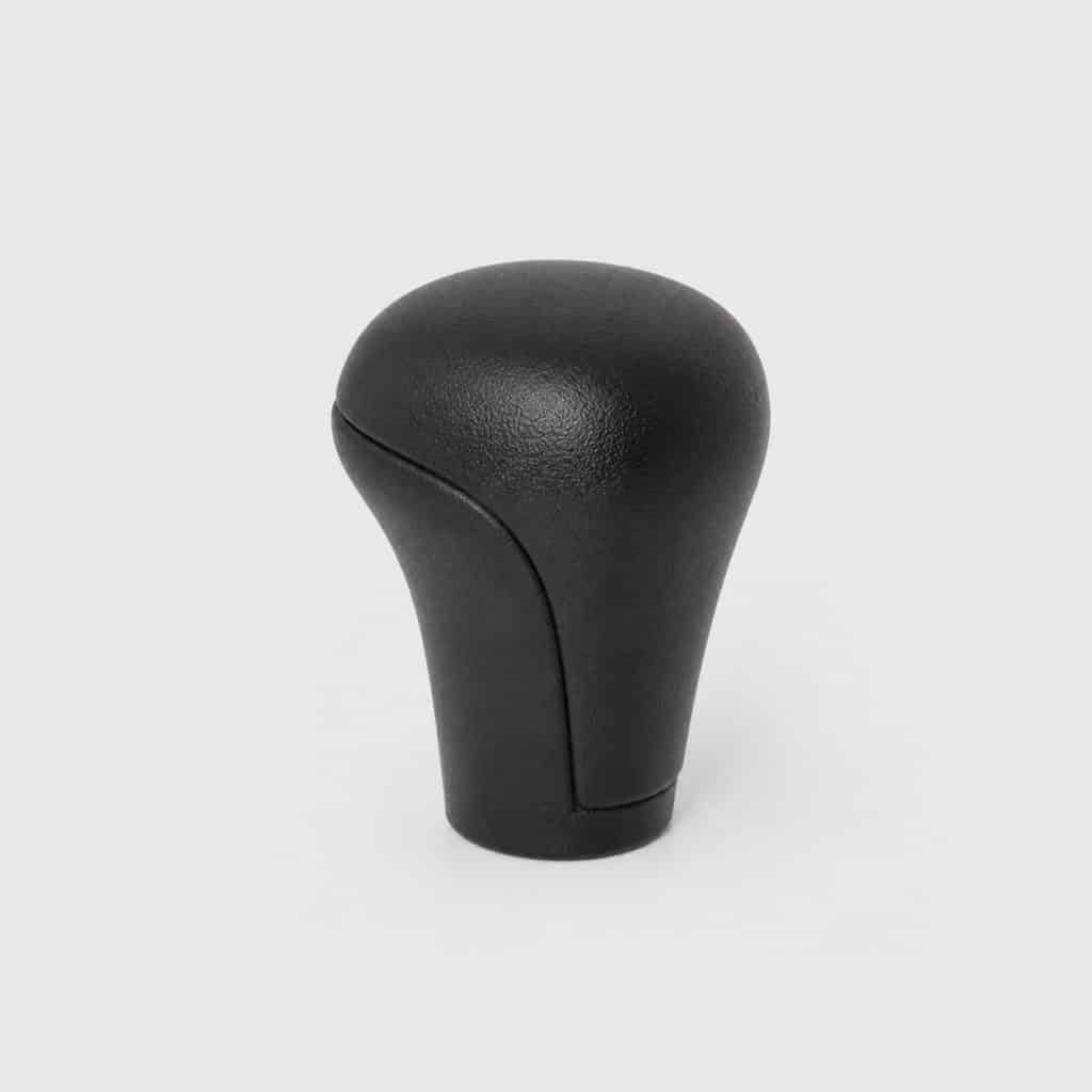 Pommeau de levier de vitesse compact présenté seul sur fond clair